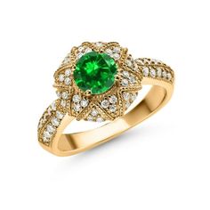 a gold ring with an emerald and white diamonds on the band, set in 18k yellow gold