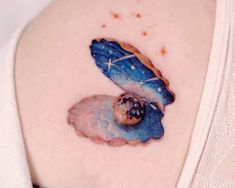 a woman's stomach with a small tattoo of a blue butterfly on the side