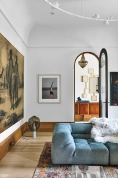 a living room filled with furniture and paintings