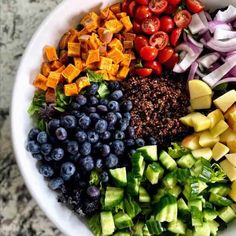 a white bowl filled with different types of vegetables