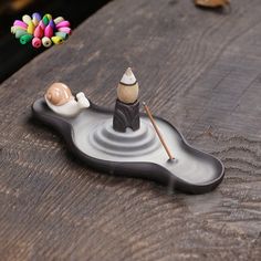 a small figurine sitting on top of a wooden table