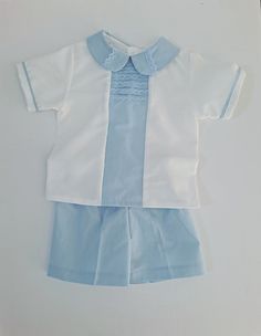 Beautiful baby outfit, custom made by hand for a 24 months littler boy. It was made with imported fabrics, white cotton for the shirt and baby light fabric for the shorts and accents. Enhance with a white lace on front. Very comfortable and it will give your little prince another reason to be more charming. You will love it so much as I do. Cotton Baptism Sets, Light Blue Fitted Short Sleeve Sets, White Boy Outfit, Cruise Clothes, Boy Dress, Baby Boy Shirts, Baby Boy Dress, Baby Light, Shirt And Shorts