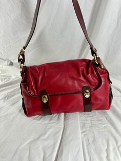 "Measurements are 15\" wide, 9\" high, 5\"5  deep with one 37\" shoulder strap at its longest with a 17\" drop. There is one  inner compartment lined in colorful signature fabric, back zipper pocket, front closures along with a front zipper pocket under flap.  This  genuine Marino Orlandi  leather shoulder bag is made of two tone red leather, gold tone hardware and one back zipper pocket for easy to access items. There are a few very light scuffs on leather along with a light ink mark on the bottom with no tears or holes.  Made in Italy by Marino Orlandi. ----------------------------------------I SHIP WORLDWIDE------------------------------------------------- I want to stress that item is vintage which means it's not new. All my customers are very important to me and I believe communicatio Vintage Baguette Bag With Removable Pouch For Travel, Vintage Baguette Bag With Adjustable Strap For Travel, Vintage Leather Baguette Bag With Detachable Strap, Classic Red Satchel With Leather Lining, Red Shoulder Bag With Leather Lining And Double Handle, Vintage Red Shoulder Bag For Travel, Red Shoulder Bag With Double Handles, Classic Red Leather Shoulder Bag, Classic Red Flap Bag