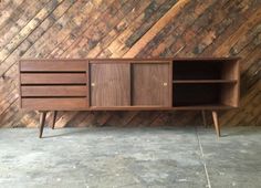 the sideboard is made out of wood and has two doors on one side, and three drawers on the other