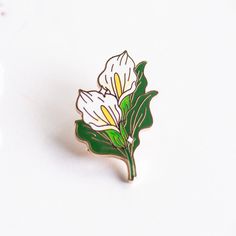 a white flower pin sitting on top of a table