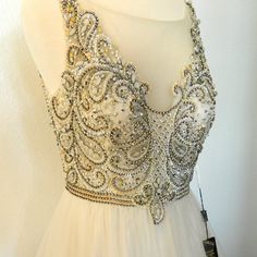 a white dress with lots of beads on it