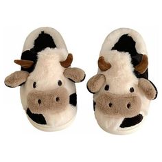 a pair of slippers with a cow on them