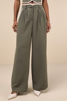 Walk into any room feeling put-together in the Lulus Composed Aesthetic Olive Green Color Block Wide-Leg Pants! Lightweight woven twill shapes these elevated pants that have a high, notched waist with a hidden zip fly and top clasp closure, belt loops, and front diagonal pockets. Front pleats enhance the chic silhouette, atop wide legs that fall to ankle-length hems. Bonus decorative welt pocket at back. White color block trim lines the waist and pockets for a stylish finish. Pair with the match Khaki Wide Leg Pants For Work, Khaki Wide-leg Workwear Bottoms, Khaki Wide Leg Workwear Bottoms, Loose Fit Khaki Wide Leg Pants For Work, Khaki Wide-leg Pants For Work, Workwear Khaki Bottoms With Elastic Waistband, Khaki Bottoms With Elastic Waistband For Work, Chic Khaki Wide Leg Cargo Pants, Khaki Wide Leg High-waisted Pants With Elastic Waistband