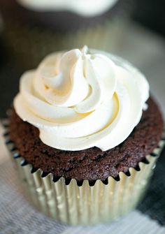 a chocolate cupcake with white frosting on top