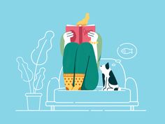 a person sitting on a couch reading a book with a dog looking at them in the background