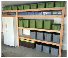 there are many storage bins on the shelves