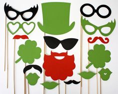 a group of mustaches, hats and glasses on sticks with green leaves in the middle