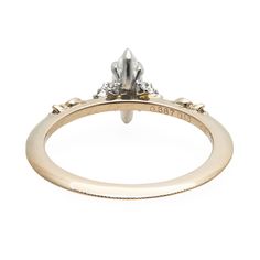 A vertically set marquise diamond in a ring that is wholly Kataoka in feeling, which means celestial, considered, and of the highest craftsmanship. The first marquise diamond came to be when Louis XV asked his jewelers to cut a stone in the shape of the lips of his lover, Marquise de Pompadour. Made in the tiny, magical Tokyo workshop of master jeweler Yoshinobu Kataoka.See Details for item specifics (carat weight, metal, etc).Financing options available in partnership with Affirm. Marquise Diamond White Diamond Ring For Promise, Promise Ring With Single Diamond In Marquise Shape, Marquise Promise Ring With Single Diamond, Marquise Cut Diamond Promise Ring With Single Cut Diamonds, Marquise Rose Cut Diamond Promise Ring, Marquise Cut Ring With Single Diamond For Promise, Marquise Single Diamond Promise Ring, Timeless Marquise Cut Diamond Ring With Rose Cut Diamonds, Silver Marquise Cluster Ring