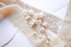 Our Long Floral Bridal Earrings feature freshwater pearls and are perfect for any special occasion. Crafted from durable materials, the pearls offer a delightful finishing touch. - Handcrafted with clay flowers, freshwater pearls - Available in rose gold, yellow gold or bright silver - Earrings measure 4.25 inches long - Nickel free and hypoallergenic Matching pieces: https://www.etsy.com/listing/1584210790/floral-bridal-bracelet-rose-gold?click_key=ec22bdc856b2549a597563b442abddca675f02cd%3A1584210790&click_sum=0e9bb3d1&ref=shop_home_active_1&frs=1&sts=1 https://www.etsy.com/listing/1584225468/floral-bridal-hair-comb-wedding-hair?click_key=f9cd6e16d327174ff88c059263cb4506c3a1432d%3A1584225468&click_sum=4e3d0354&ref=shop_home_active_1&frs=1&sts=1 Rose Gold Pearl Earrings For Wedding, Rose Gold Dangle Pearl Earrings For Wedding, Rose Gold Pearl Bridal Earrings For Wedding, Rose Gold Pearl Bridal Earrings For Anniversary, Anniversary Rose Gold Pearl Bridal Earrings, Delicate Rose Gold Pearl Earrings For Wedding, Rose Gold Pearl Earrings For Anniversary, Anniversary Rose Gold Pearl Earrings, Bracelet Rose Gold