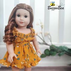 a doll with long hair wearing a yellow dress