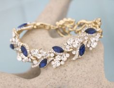 Navy blue crystal bracelet, wedding bracelet, rose gold, navy blue, something blue bracelet Bridal jewelry bracelet Rhinestone bracelet Crystal Wedding bracelet Wedding jewelry Sapphire bracelet  This stunning Rhinestone something blue bracelet is a beautiful addition to your wedding day. Size : length is 6" X  width 0.75" . Tone colour: - Silvertone - Gold-tone - Rose gold-tone Finish Crystal Color : # 1 - Light Amethyst # 2 - Emerald # 3 - Red # 4 - Light Topaz # 6 - Indicolite #10 - Amethyst Blue Crystal Bracelets For Wedding, Sapphire Crystal Bracelet, Blue Cubic Zirconia Wedding Bracelet, Bridal Jewelry Bracelets, Silver Wedding Bracelet, Rose Water Opal, Blue Crystal Bracelet, Jewelry Sapphire, Bracelet Rose Gold