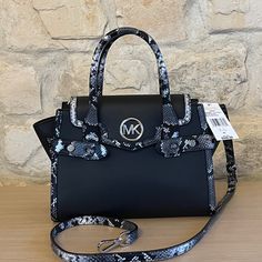 Guaranteed Authentic Brand New With Tags Attached Nwt Michael Kors Carmen Medium Flap Satchel Shoulder Color: Black Multi Satchel Classic Trapeze Shape Adjustable Belted Side Gussets Trim: 100% Polyester Silver -Tone Hardware Approximately 11"W X 7.75"H X 5"D Handle Drop: 4.75” Exterior Details: Detachable Crossbody Strap Interior Details: Back And Front Slip Pockets Lining: 100% Polyester Push-Lock Fastening Smoke/Pet Free Environment Michael Kors Black Top Handle Bag, Michael Kors Satchel With Detachable Handle, Black Michael Kors Bag, Michael Kors Black Satchel For Travel, Michael Kors Black Evening Satchel, Michael Kors Black Satchel With Adjustable Strap, Black Michael Kors Bag With Top Carry Handle, Michael Kors Black Bag With Top Carry Handle, Michael Kors Black Top Handle Satchel