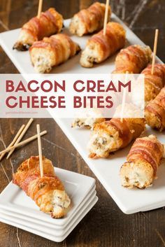 bacon cream cheese bites with toothpicks in them on a white platter next to other appetizers