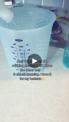 a measuring cup filled with blue liquid on top of a counter