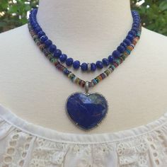 With its stunning in simplicity design and gorgeous colors, this necklace represents the universal symbol of love. The faceted, domed heart of natural lapis is surrounded with sparkling pave diamonds. The pendant hangs from a colorful beaded necklace. There are so many colorful gems in this necklace! Turquoise, lapis, larimar, blue agate, peridot, carnelian, amethyst and more! Alone or layered with your other favorites, its flirty elegance gives it a statement making vibe. Pendant: 32mm x 35mm ( Elegant Multicolor Necklace With Heart Charm, Elegant Multicolor Heart Cut Necklace, Handmade Multicolor Beaded Necklace With Heart Pendant, Spiritual Jewelry With Heart Pendant And Natural Stones, Artisan Heart Necklace With Natural Stones, Elegant Multicolor Heart Beads Necklace, Elegant Heart-shaped Gemstone Bead Jewelry, Multicolor Heart Beads Sterling Silver Jewelry, Multicolor Sterling Silver Heart Beads Jewelry