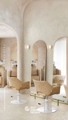 the interior of a salon with chairs, mirrors and stools in beige color scheme