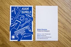 a business card with an image of a desk top computer and office supplies on it