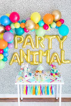 a party animal table with balloons and streamers