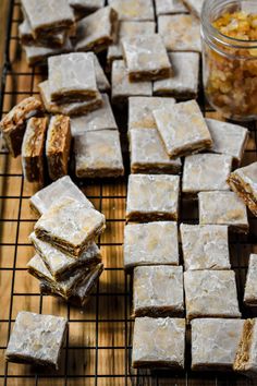 there are many small squares of food on the cooling rack next to some other items