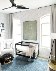 a baby's room is decorated in white and blue