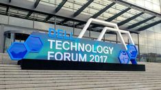 the dell technology forum logo is displayed on steps outside an office building with stairs leading up to it