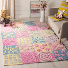 a living room area with a rug, chair and teddy bear on the floor in front of it