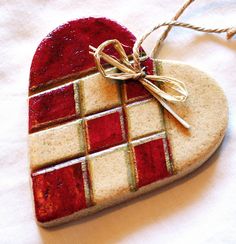 a heart shaped ornament with a bow on it