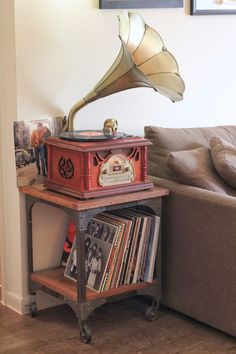 a living room with a couch, coffee table and an old fashioned record player on it