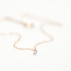 A shining diamond pricked through with a small shot of platinum, tethered to a fine 100% recycled solid gold chain. Warning: this bracelet catches the light extravagantly, your friends will stop mid-sentence, clutch your arm and ask: WHAT is that. To whic Dainty Rose Gold Solitaire Necklace With Adjustable Chain, Rose Gold Dainty Solitaire Necklace With Adjustable Chain, Dainty Rose Gold Jewelry With Single Diamond, Rose Gold 14k Gold Solitaire Necklace With Delicate Chain, Minimalist Rose Gold Diamond Necklace With Adjustable Chain, Rose Gold 14k Single Diamond Necklace, Rose Gold Diamond Cut Necklace For Everyday, Delicate Rose Gold Jewelry With Single Diamond, Everyday Rose Gold Diamond Cut Necklace