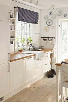 the kitchen is clean and ready to be used for cooking or baking, with dishes hanging on the wall