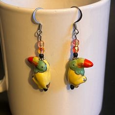 These Handcrafted One Of A Kind Earrings Are Made With Ceramic Toucans/Parrots, Czech Glass And Fish Hook Ear Wires. Earrings Measure 1 1/2”. Designed And Handcrafted By Me. Animal Parrot Toucan Amazon Rainforest Trees Nature Jewelry Artisan Art Jewelry Earrings Dangle Drop Dangly Glass Yellow Green Red Spring Summer Fall Handcrafted Handmade New To Poshmark? Make An Account And Use Code Ambentzen And Get $10 Off Your First Purchase Poshmark Ambassador 2 Posh Mentor Non Smoking Home Quick Shippi Amazon Rainforest Trees, Toucan Earrings, Rainforest Trees, Art Jewelry Earrings, Trees Nature, Amazon Rainforest, Nature Jewelry, Top Seller, Earrings Dangle