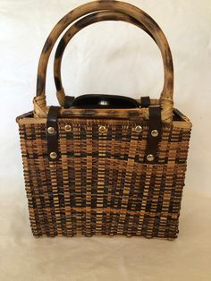 Basket weave handbag, bamboo handles, rectangular, not lined, 9x8x4.  Brass  Hardware,  Lovely pre-owned condition. No scars. No Issues.  Clean.  Shipping includes Insurance. We are always open to reasonable offers. Thank you for shopping Two Fat Cats USA and stay safe. Rectangular Brown Straw Bag For Picnic, Rectangular Straw Bag With Bamboo Handle For Picnic, Brown Rectangular Straw Bag For Picnic, Rectangular Straw Bag With Braided Handles For Picnic, Rectangular Straw Bag With Bamboo Handle, Rectangular Straw Bag With Leather Handles For Picnic, Rectangular Bags With Leather Handles For Picnic, Rectangular Straw Bag With Handles, Rectangular Straw Bag With Rolled Handles