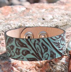 Leather cuff bracelet that has two snaps for adjustability. Made in USA Turquoise Stamped Cuff Bracelet Bangle, Western Style Stamped Turquoise Cuff Bracelet, Turquoise Stamped Western Cuff Bracelet, Vintage Cuff Leather Bracelet Gift, Stamped Leather Vintage Cuff Bracelet, Leather Cuffs Bracelet, Leather Cuffs, Cuff Bracelet, Brown Leather