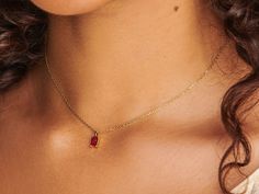 A dainty stone and delicate metallic chain are combined to create this Gold Pendant Necklace in brilliant ruby, your new favorite wear-anywhere accessory. The birthstone for the month of July is Ruby. This bold, saturated red gemstone helps the wearer overcome challenges and symbolizes courage and passion. Authentic ruby stone; Made of 14K gold-filled. Pendant size: 6mm x 4mm with 18" chain. Hypoallergenic, nickel, and lead-free. Tarnish resistant. Ideas to choose your Birthstone Necklace: Your Ruby Birthstone Necklaces, Dainty Ruby Gemstone Birthstone Necklace, Red Gemstone Birthstone Necklace Fine Jewelry, Red Birthstone Necklace With Lab-created Ruby, Fine Jewelry Red Gemstone Birthstone Necklace, Dainty Ruby Gemstone Necklace, Red Lab-created Ruby Birthstone Necklace, Red Ruby Birthstone Necklaces, Red Ruby Gemstone Birthstone Necklace