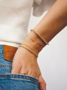 A must-have for every arm party, our Everyday Stretch Bracelets were made for stacking! Mix in this mid-sized style to your stack for a fun new shape and shimmer. Designed with durability in mind, our gold-fill beads are secured on extra-strength stretch cord to withstand your busy life and maintain their shine. Whether you dress them up, dress them down, or pile them on, you’ll truly never take them off. Gold Stackable Cuff Bracelet For Everyday, Everyday Stackable Beaded Bangle Bracelets, Trendy Everyday Stackable Gold Bracelet, Trendy Tarnish Resistant Bracelet For Everyday, Trendy Gold Stackable Stretch Bracelet, Gold Wrap Bracelet For Layering, Gold Jubilee Bracelet For Everyday Wear, Trendy Everyday Jubilee Bracelet, Stackable Bangle Bracelets For Everyday