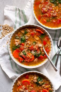 two bowls filled with soup sitting on top of a table