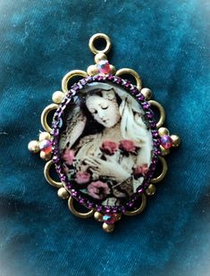 Captivating Image of the Virgin Mary  embellished a silver chain, crystals in a gold setting. This Devotional jewelry is handmade, Pendant  is One-of-a-kind. And protected on the surface with clear resin.  36"x5/8" velvet frayed ribbon included. New & refurbished Vintage components are used to make this one-of-a-kind piece of artistic jewelry. Religious Pendants, Mary, Madonna Jewelry, Necklaces , Mary Ornament, Mary Icon, Gift of Faith, Religious Gift, Pendants are Gift boxed with religious ima Oval Rhinestone Jewelry Gift, Oval Shaped Rhinestone Jewelry For Gifts, Costume Jewelry With Rhinestones For Gifts, Gold Jeweled Jewelry Gift, Gold Jeweled Jewelry For Gifts, Jeweled Metal Necklaces As A Gift, Gold Jeweled Necklace For Gift, Jeweled Metal Jewelry Gift, Vintage Rhinestone Necklace For Gift