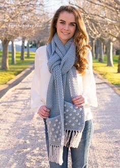 a woman wearing a gray scarf and jeans