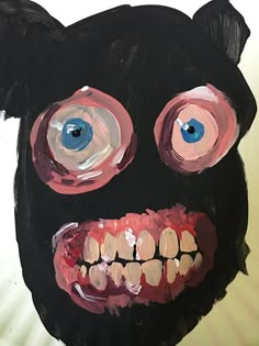 a painting of a black bear's face with blue eyes and red teeth is shown