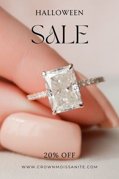 a woman's hand holding an engagement ring with the words halloween sale on it