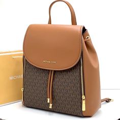 Brand New With Tag Michael Kors Medium Phoebe Flap Drawstring Backpack Pvc Leather Color: Vanilla Gold Toned Hardware Mk Brown Signature Color Michael Kors Logo On Front 2 Side Zip Pocket At Front Flap Snap Top Closure Custom Fabric Lining 2 Slip In Pocket 1 Zipper Pocket 11.75" (L) 13"(H) 5.25"(D) 3.25" Top Handle, Adjustable Backpack Straps Michael Kors Backpack With Detachable Strap, Luxury Michael Kors Backpack With Detachable Strap, Leather Backpack With Branded Hardware For Travel, Designer Leather Backpack For Errands, Luxury Backpack For Errands, Michael Kors Rhea Backpack, Michael Kors Mini Backpack, Mini Leather Backpack, Studded Backpack