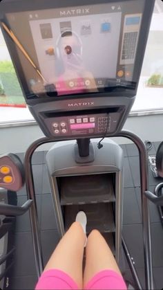 a person on a treadmill with their feet in the machine and one leg up