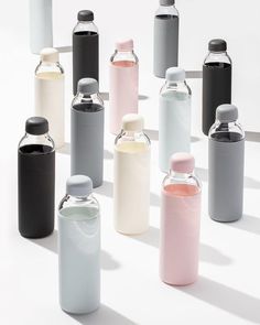 many different colored bottles are lined up together