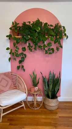 an empty room with a plant on the wall and a shelf in the corner above it