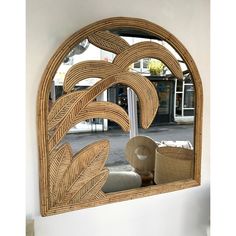 a mirror that is on the side of a wall with a plant in it and some baskets